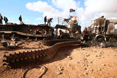 Reuters  ¦  Destroyed weapons belonging to forces loyal to Libyan leader Moammar Gadhafi, after a coalition air strike along a road between Benghazi and Ajdabiyah on Monday.