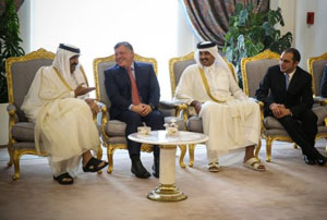 Jordan's king and prince congratulate the former emir of Qatar (L) and new emir (2nd R) in Doha