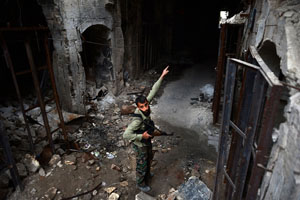 Syrian rebel fighter points to destruction in the Umayyad Mosque 