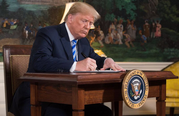 U.S. President Donald Trump signs a document reinstating sanctions against Iran after announcing the U.S. withdrawal