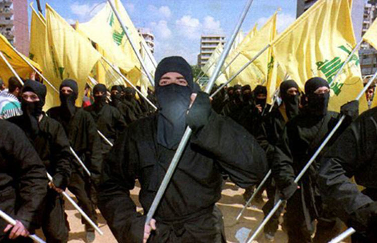 Hezbollah fighters hold flags