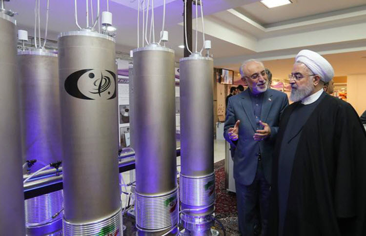 Iranian President Hassan Rouhani (right) listening to head of Iran's nuclear technology organisation Ali Akbar Salehi (second from right) during the "nuclear technology day" in Tehran