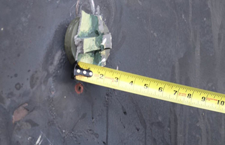 In this handout photo provided by the U.S. Department of Defense, the aluminum and green composite material left behind following removal of an unexploded limpet mine used in an attack on the starboard side of motor vessel M/T Kokuka Courageous is seen on June 14, 2019 in the Gulf of Oman.