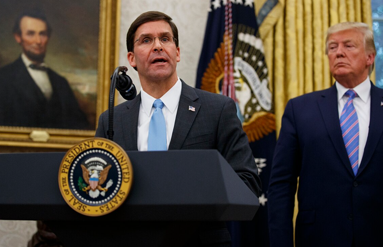 President Donald Trump looks to Secretary of Defense Mark Esper during a ceremony in the Oval Office at the White House 
