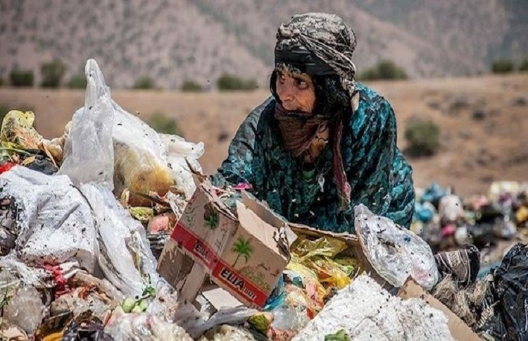  Poor Iranian woman searches in the garbage for food, a glimpse of what is becoming a daily image in Iran